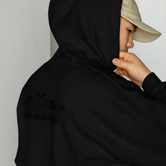 Sweat à capuche oversize noir Fast Mood Monkey, un vêtement streetwear unisexe qui incarne le mood 'Unleash your inner vibe' avec son logo de singe graphique dans le dos